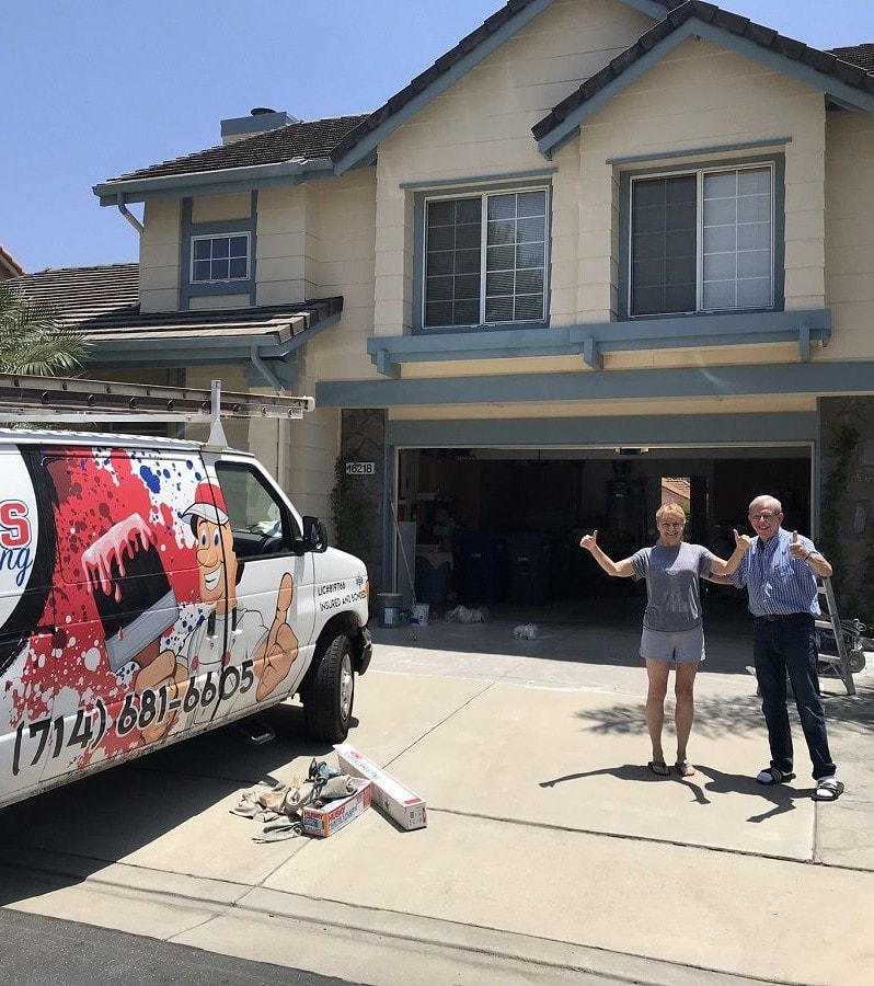 a happy couple standing next to a color concepts van